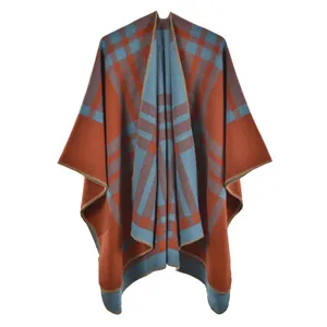 Detail view of thickened plaid poncho wrap showing brown and light blue woven texture
