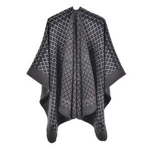 Close-up of geometric diamond pattern and woven texture on grey knit shawl poncho