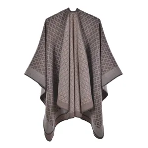 Detail of geometric diamond knit shawl showing thick wool texture and taupe pattern weave