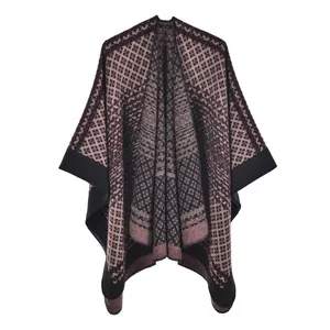Detail of geometric diamond pattern knit poncho with black trim and vintage style