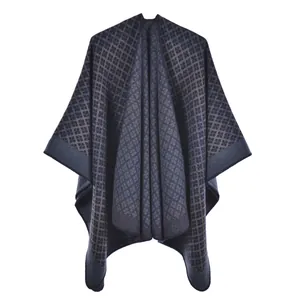 Detailed view of dark blue and grey geometric diamond knit texture on winter poncho