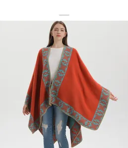 Detail of warm orange ethnic knit shawl with turquoise geometric jacquard pattern