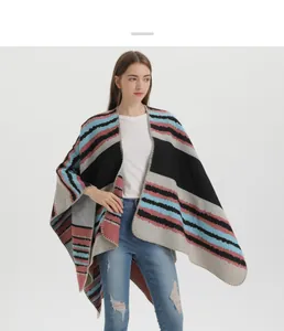 Detail shot of striped cashmere-like knit shawl with wavy texture and finished edges