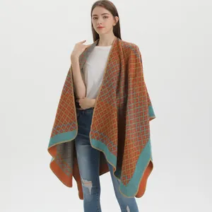 Women's knit poncho with geometric diamond pattern in orange and teal blue colors
