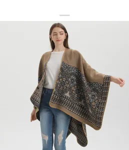 Detailed knit texture of a camel floral shawl wrap with geometric fringe patterns