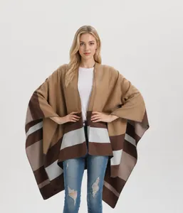 Close-up of knit shawl poncho featuring earth-tone stripes and high-quality edge stitching