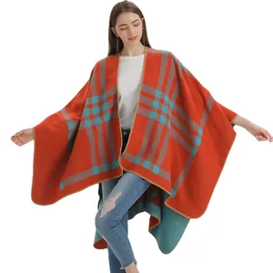 Plaid cashmere-like poncho wrap in orange and teal blue with classic knit fringe