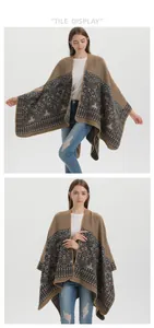 Detailed view of brown knitted poncho featuring retro floral patterns and scalloped edges