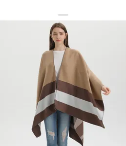 Detail of soft knit shawl cape with brown and grey stripes on a modern female outfit