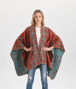 Close-up of vintage jacquard knit shawl featuring ethnic orange and teal floral patterns