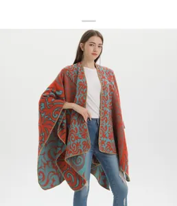 Close-up of retro totem jacquard knit shawl with red and teal contrast patterns