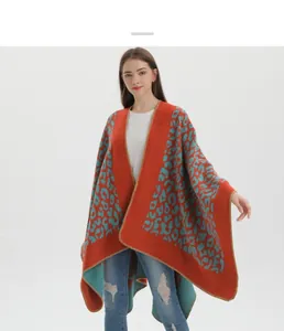 Detail of orange knit shawl with blue leopard print and gold edge stitching for women