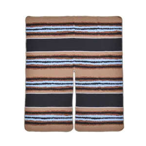 Detail of multi-color striped knit poncho with zigzag patterns and fine edge stitching