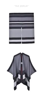 Detail of soft knit shawl cape with elegant black, grey, and burgundy striped texture