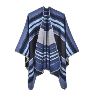 Detail of vintage bohemian knit shawl with blue stripes and decorative hand-stitched edges
