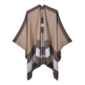 Close-up of the knitted texture and classic striped pattern on a winter shawl cape