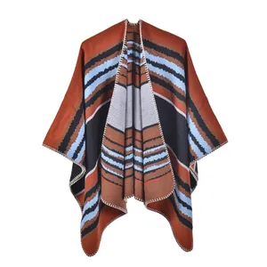 Detail view of ethnic knit poncho with geometric stripes and white blanket stitch finish