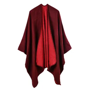 Women's burgundy knit shawl cape with contrast red lining and fine hem detailing