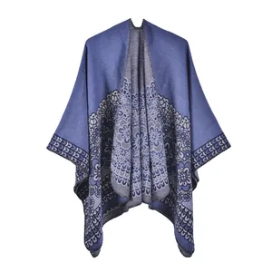 Detailed view of bohemian blue shawl with intricate grey mandala patterns and knit texture