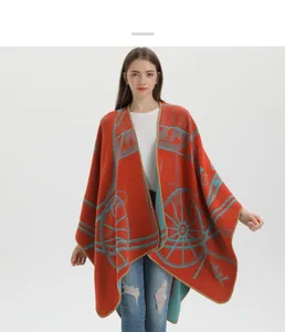 Detail of knit shawl featuring orange and blue horse carriage jacquard pattern texture
