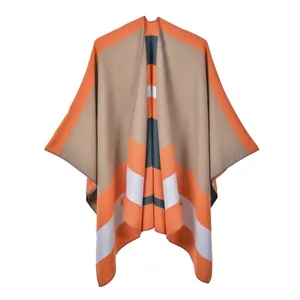 Detailed knit texture and stitched edges of the striped color block poncho shawl