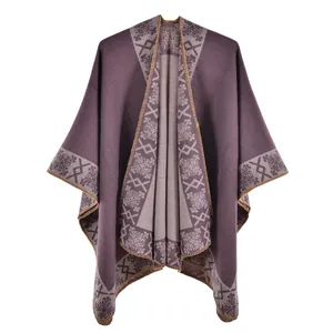Detail of grey-purple knit poncho showing jacquard patterns and lock-stitch edges