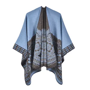 Close-up of ethnic jacquard pattern and textured knit fabric on light blue shawl