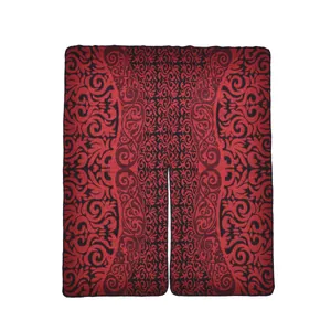 Detailed knit texture of red and black baroque totem pattern on winter shawl cape