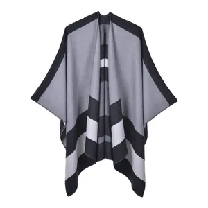 Detail of grey striped knit poncho showing the high-quality woven texture and hem finish
