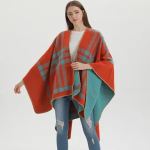 Detail of the knit texture and orange-teal plaid pattern on the women's shawl