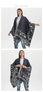 Detail of floral jacquard knit shawl with fringe tassels and split-front design