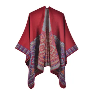 Detail of red knitted shawl with colorful ethnic floral patterns and soft texture