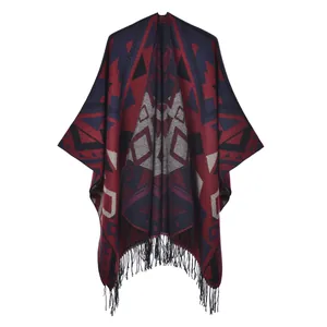 Détail d'un poncho bohème épais avec motifs ethniques et longues finitions à franges