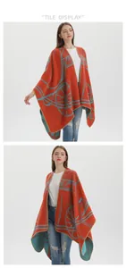 Close-up of orange knitted shawl with light blue carriage pattern and fabric texture