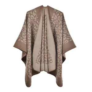 Close-up of leopard print knit texture on faux cashmere poncho with stitched edges