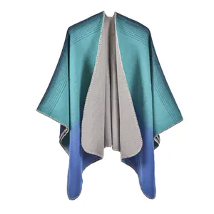 Detailed close-up of blue-green gradient knit shawl showing edge stitching and fabric texture