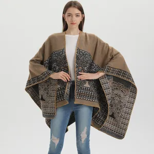 Ethnic knit shawl cloak with symmetrical mandala patterns and blanket stitch edges