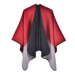 Detail of the knit gradient shawl showing black, red, and grey tones with finished edges