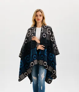 Close-up of thick knitted poncho featuring geometric patterns in blue and grey tones