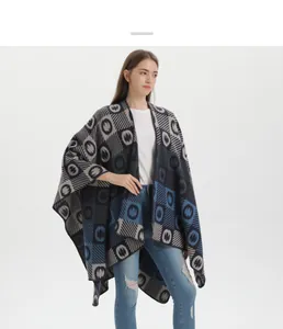 Close-up of knitted shawl with dark blue and grey geometric patterns on a model