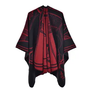 Close-up of thick red and black geometric jacquard knit shawl with drape detail