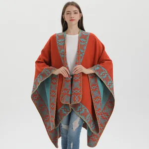 Ethnic bohemian orange knit poncho shawl with geometric patterns and blanket-stitch edges