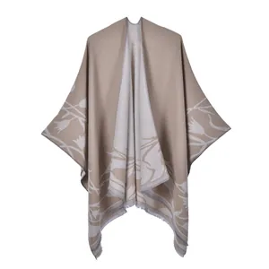 Close-up of elegant tulip print and fringe details on a double-sided beige shawl