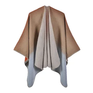 Detail of gradient knit shawl with refined overlock stitching and soft fringe texture