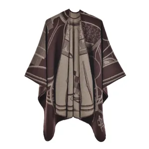 Close-up of vintage equestrian patterns on a thick brown and beige knit shawl