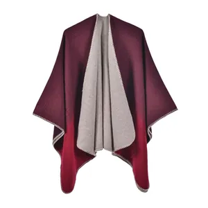 Close-up of red gradient knit shawl showing fine edge stitching and soft wool texture