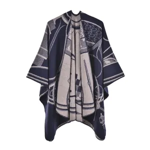 Detailed view of dark blue and beige geometric jacquard pattern on thick knit shawl