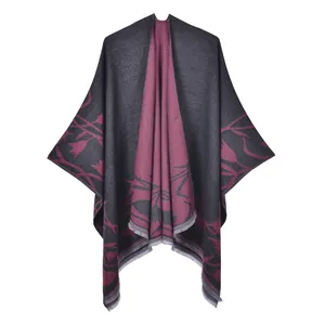 Detail of vintage double-sided shawl with plant patterns and fringe hem in grey and burgundy