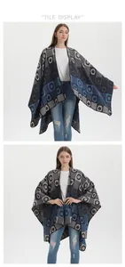 Detail of knit shawl with blue geometric patterns and irregular fringe hemline