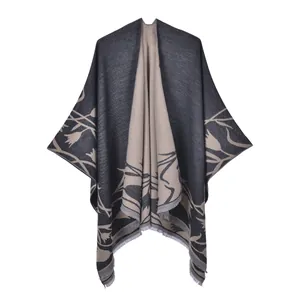 Detail of double-sided knit shawl showing khaki leaf patterns and fine tassel hemline